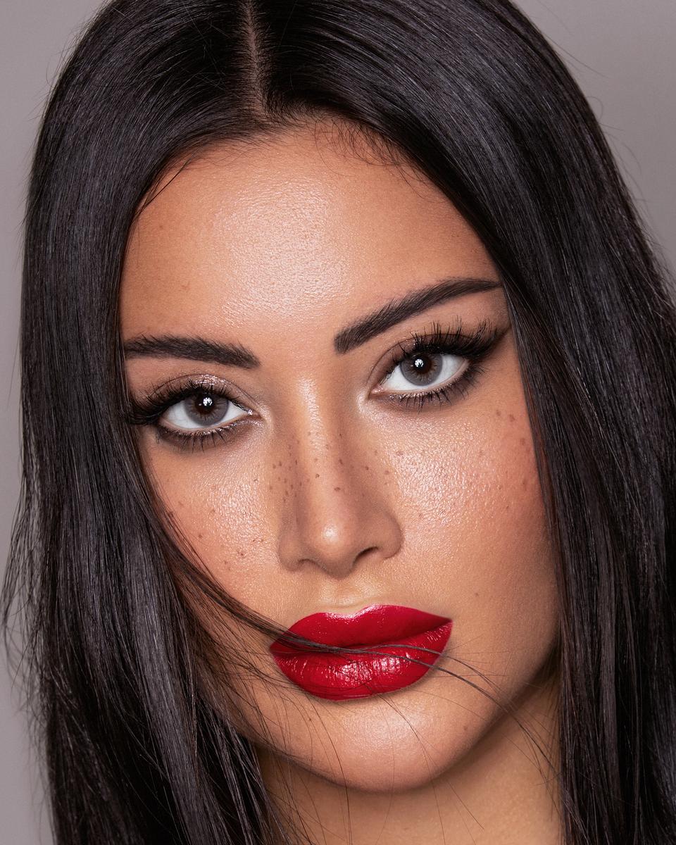 Sleek dark hair with a bold red lip
