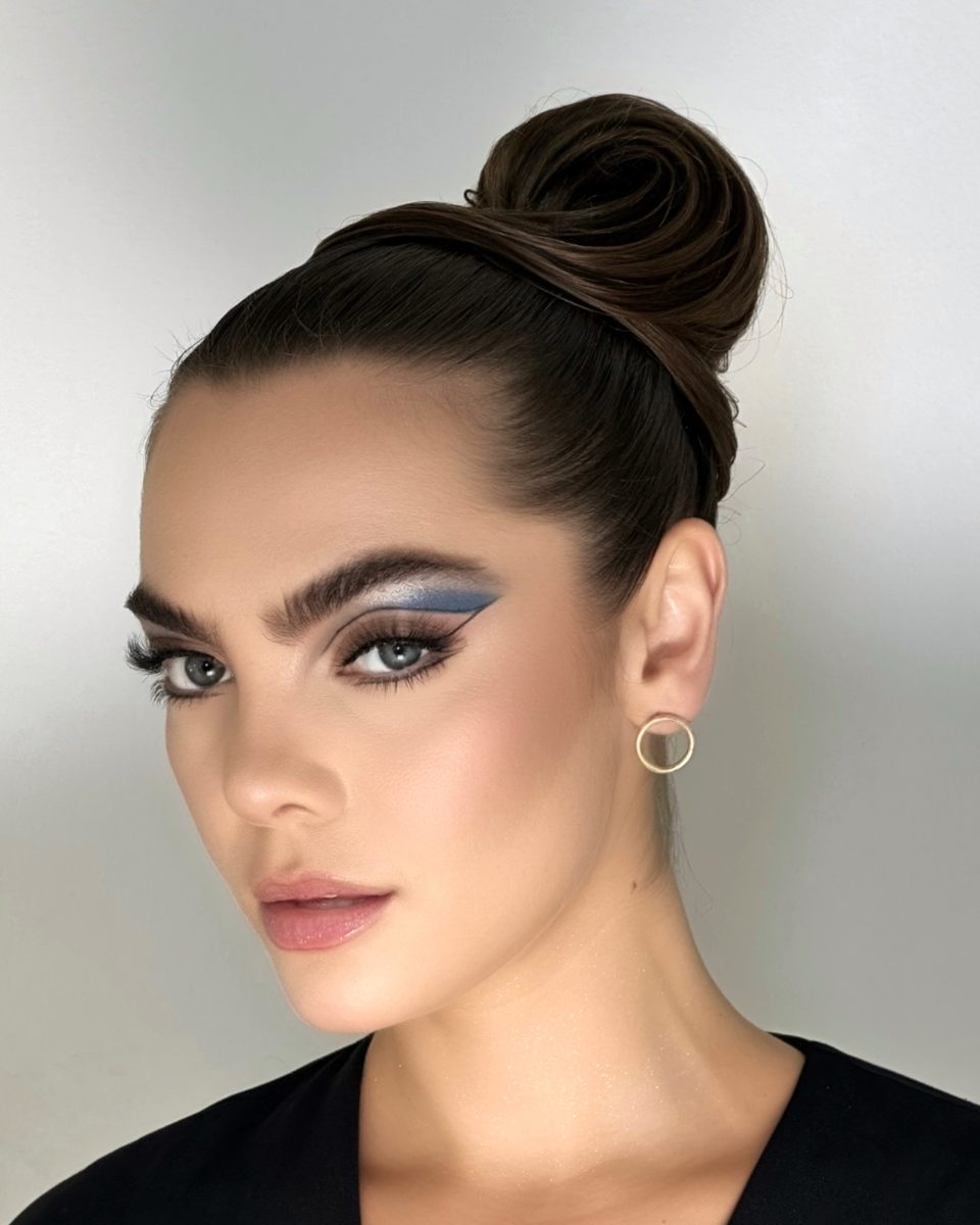Sleek high updo with editorial eye make-up at Laurance